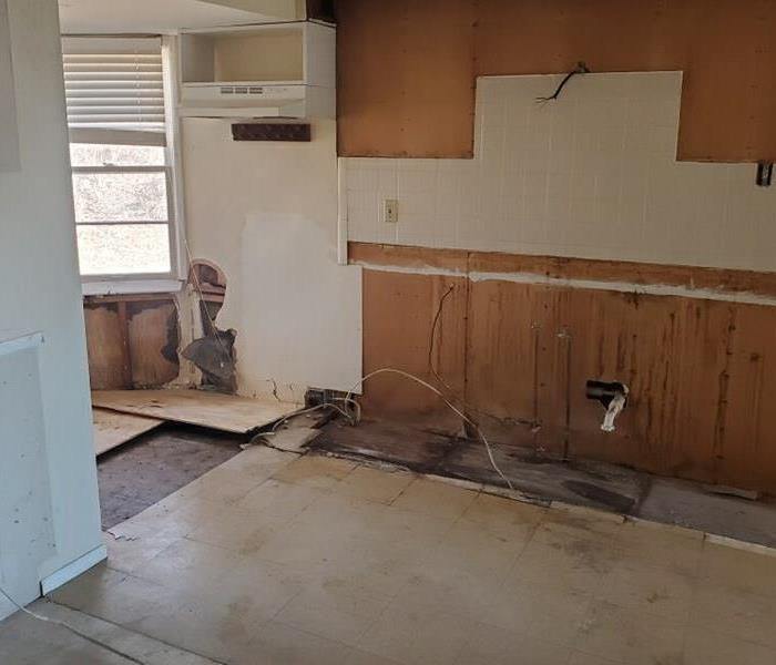A kitchen after the cabinets have been removed due to fire and water damage